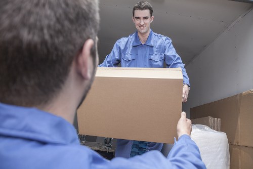 Movers handling furniture and boxes during a local house move