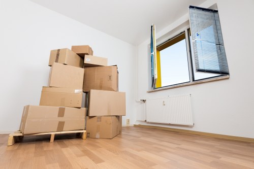 Professional movers navigating stairs in a Haringey property