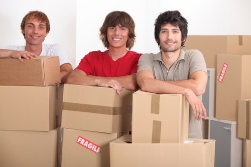 Removal crew transporting desks and boxes from a Haringey office