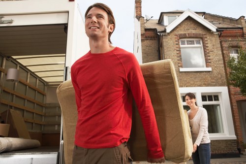 Local movers handling furniture in a Haringey family home