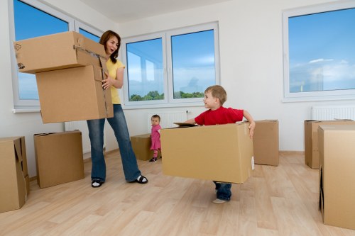 Movers carrying furniture through a Haringey property