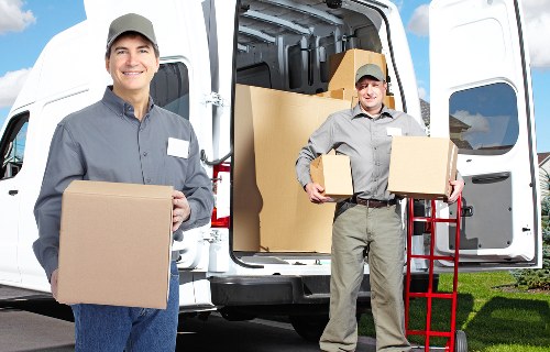 Helper carrying boxes during a flat move in Haringey